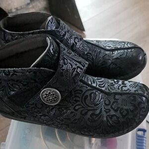 Alegria Black Floral-Embossed Slip-On Loafers with Decorative Button